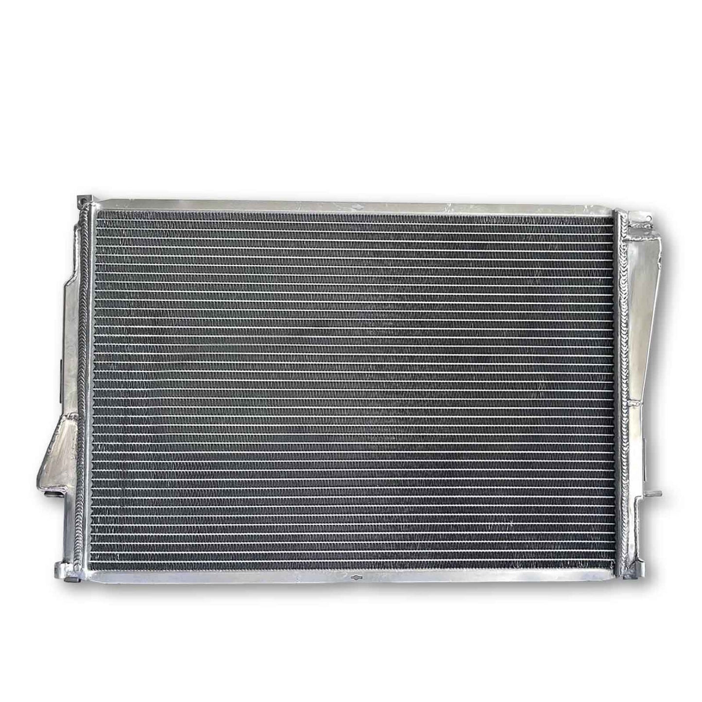 Rear view of the 3-row aluminum radiator for the BMW E46 M3, showcasing robust construction and precision mounting points for manual transmission models.