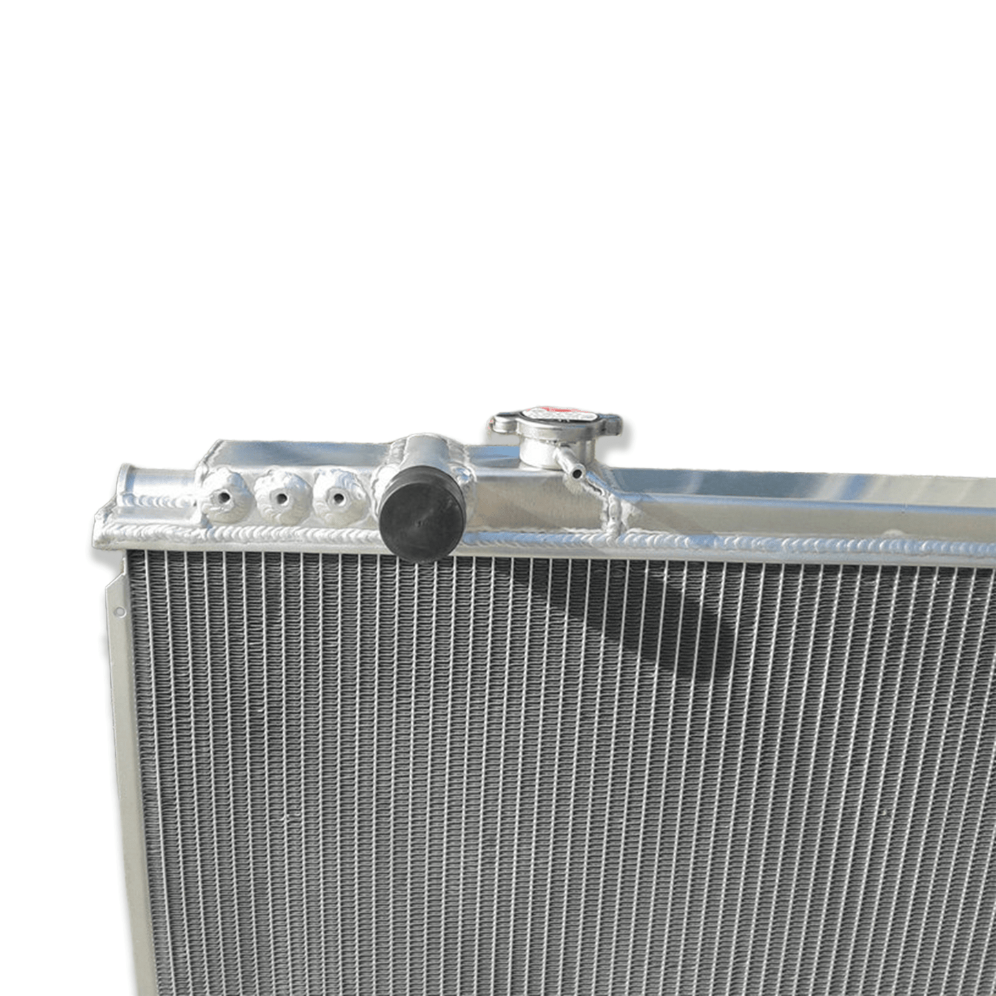 Close-up detail of the precision TIG welds and high-density cooling fins on the 3-row aluminum radiator, built for the high-performance Toyota Supra MK3 7M-GTE.