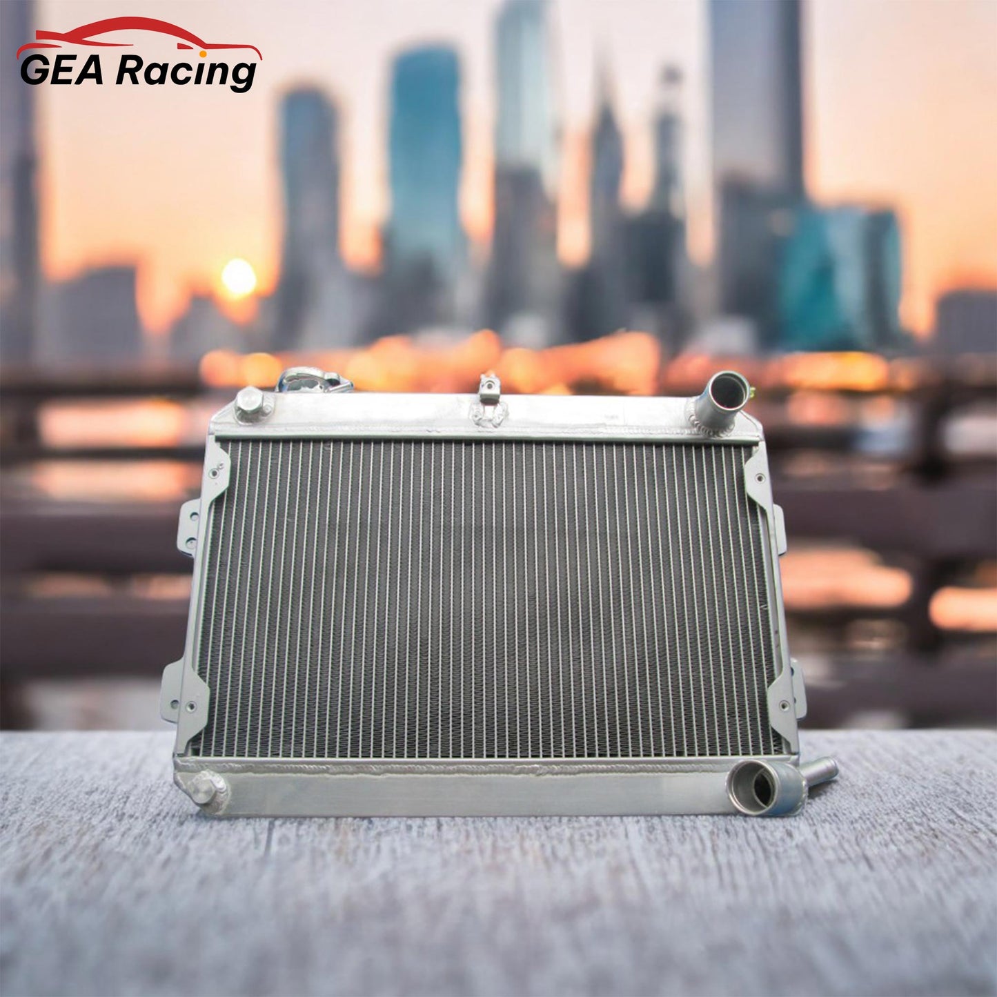 A lightweight aluminum radiator installed in a clean first-gen Mazda RX-7 (FB) engine bay, demonstrating a perfect fit and essential cooling upgrade.