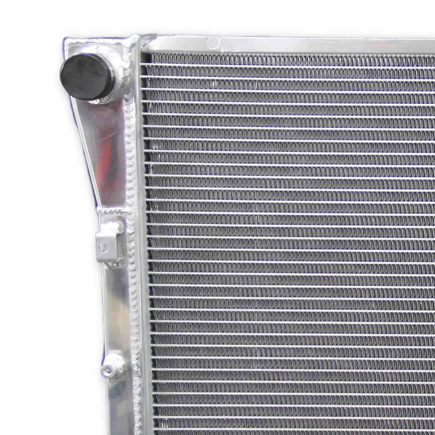 Close-up detail shot of the TIG-welded seams and high-pressure radiator cap on the 3-row performance radiator for the 1994-1996 Chevy Impala.