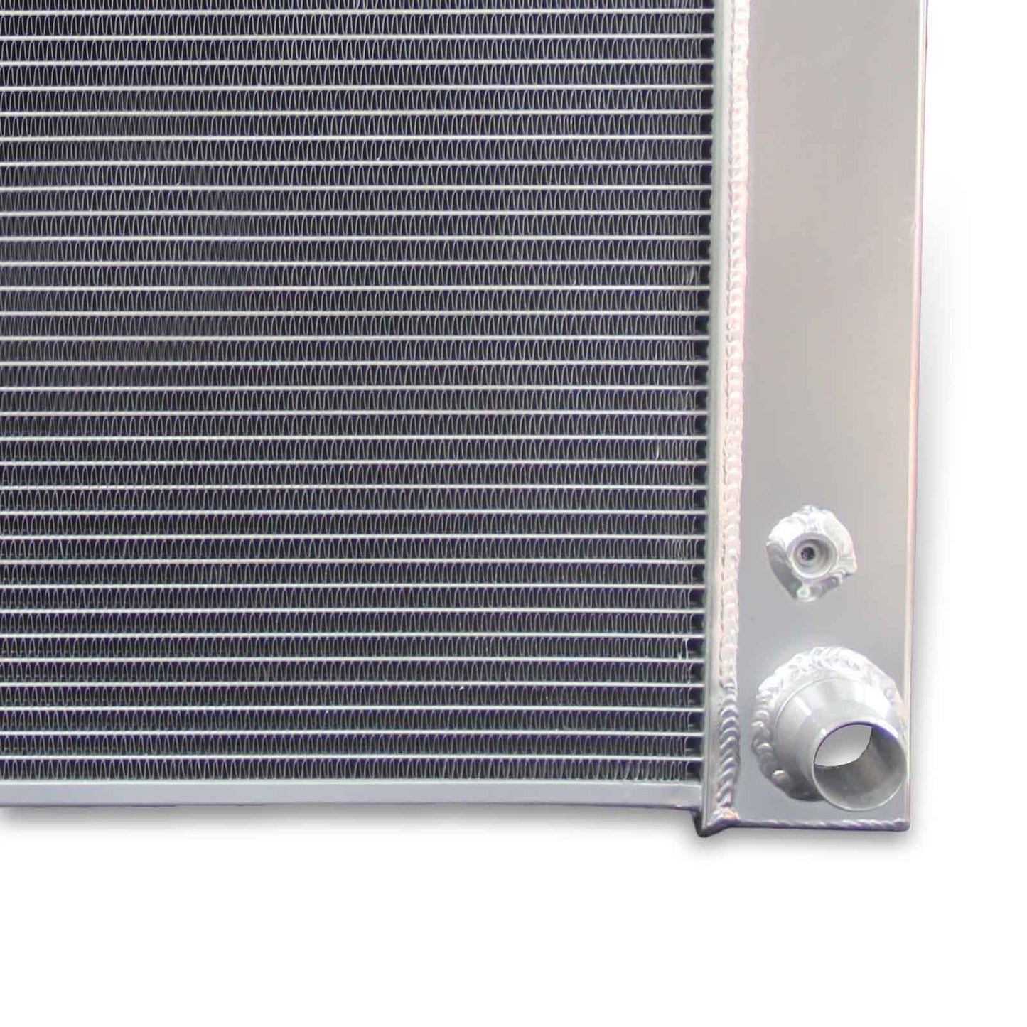 Close-up detail shot of the TIG-welded seams and high-density cooling fins on the 3-row aluminum radiator for Chevrolet Express.