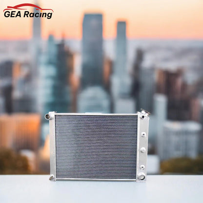 A 3 row aluminum radiator installed in the engine bay of a classic 1970s Chevrolet, showcasing a perfect fit and upgraded cooling performance.