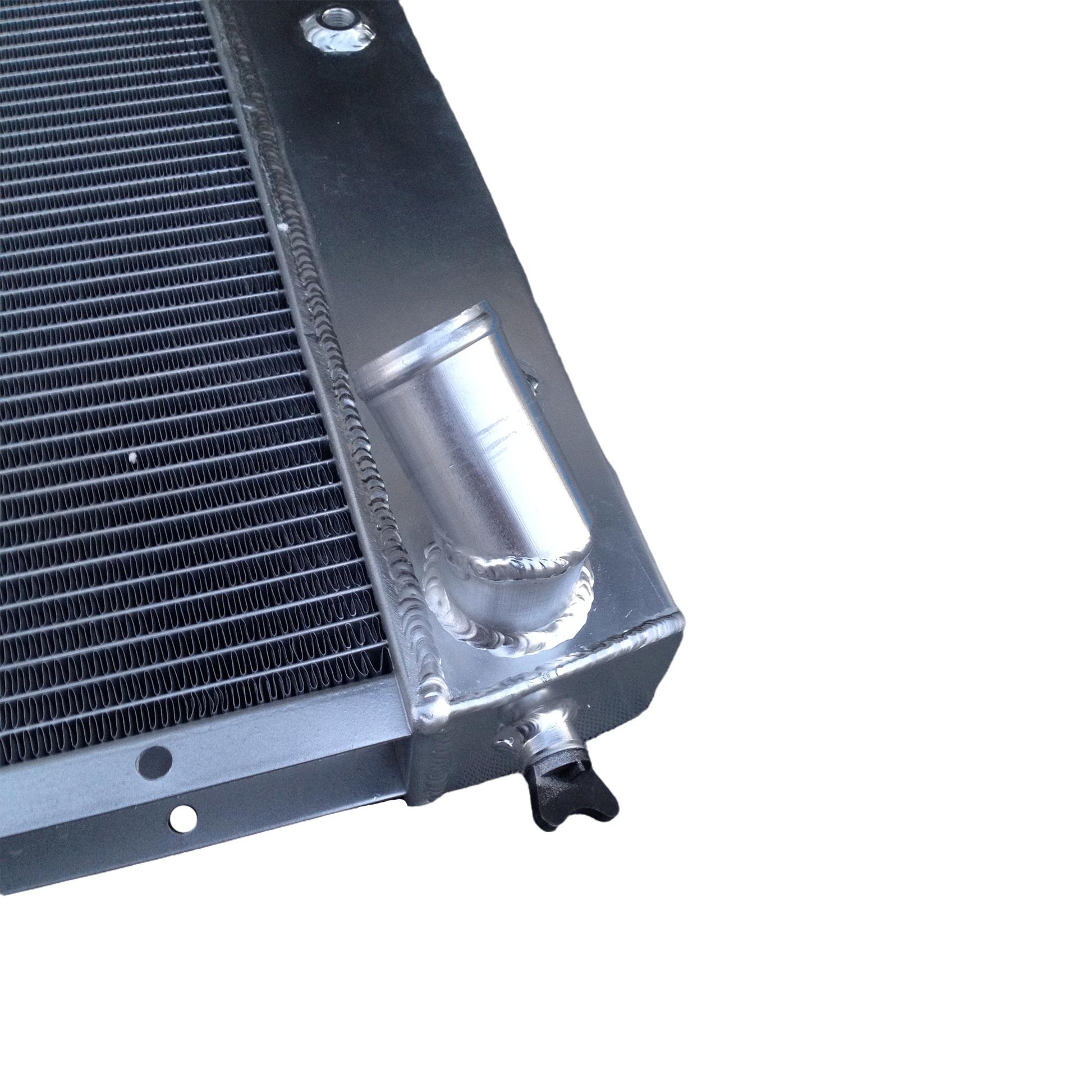 Detailed close-up of the TIG-welded seams and high-efficiency 3-row core on the radiator for a Corvette C3.
