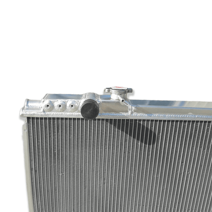 Close-up detail of the precision TIG welds and high-density cooling fins on the 3-row aluminum radiator, built for the high-performance Toyota Supra MK3 7M-GTE.