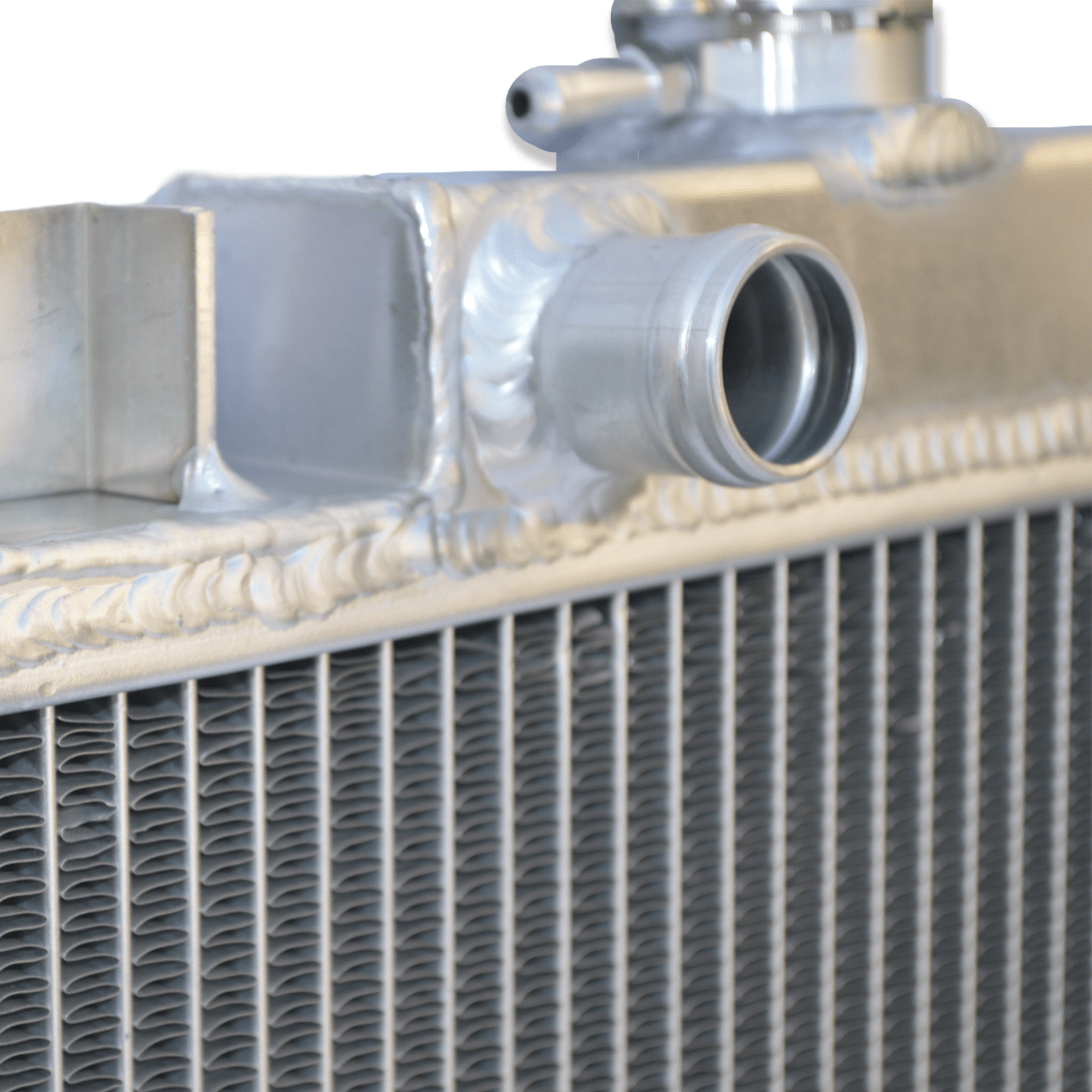 Close-up detail of the precision TIG welds on the aluminum radiator for the Suzuki Swift and Geo Metro, ensuring a durable, leak-proof service life.