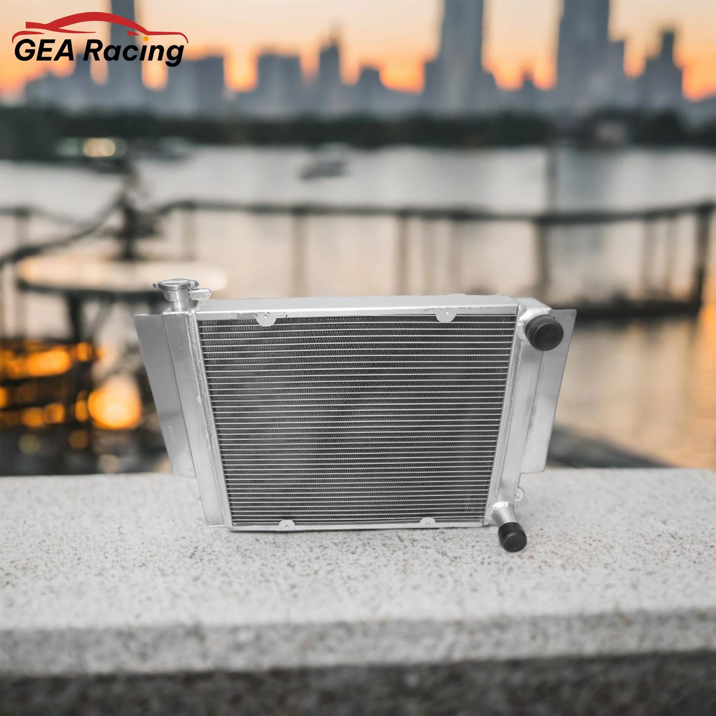 A performance aluminum radiator installed in a clean Mazda RX3 engine bay, showing a perfect fit for a heater-delete setup, ideal for a track car or simplified build.