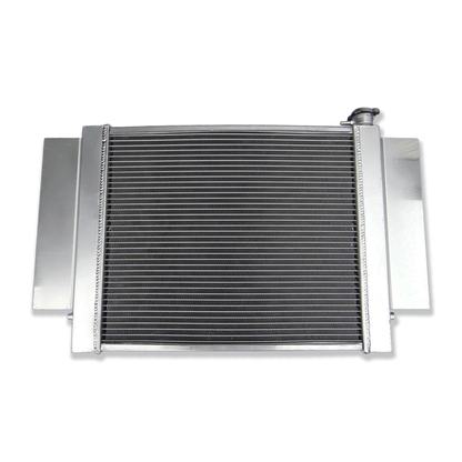 Rear view of the Mazda RX-series S1/S2 aluminum radiator, detailing the integrated heater pipe connection and precise mounting points for a direct-fit installation.