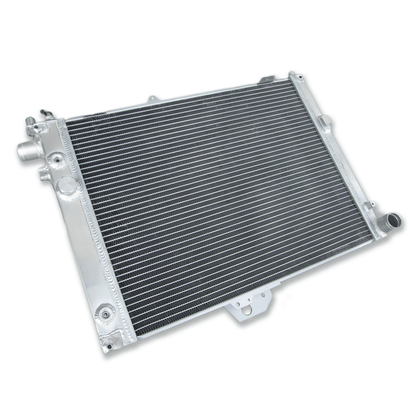 Rear view of the aluminum radiator for the SAAB 9000, showing the mounting points and integrated ports for both automatic and manual transmissions.