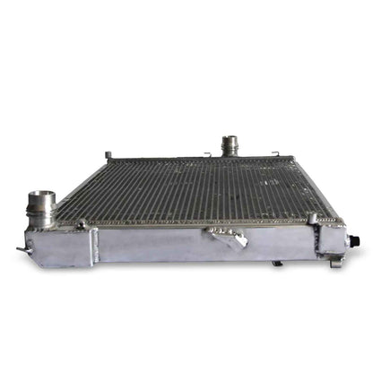 Top-down view of the 2-row aluminum radiator for the BMW E46/Z4, highlighting the bleeder screw, mounting points, and all-aluminum construction for MT cars.