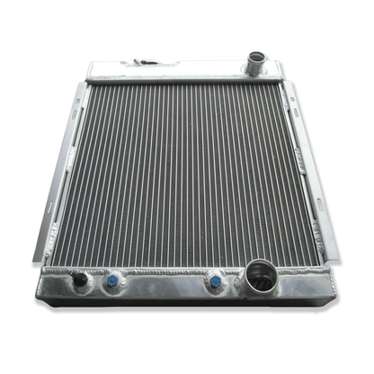 Top-down view of the 3-row radiator for the 1964-66 Ford Mustang V8, displaying the high-pressure cap and showcasing the impressive triple-core thickness.
